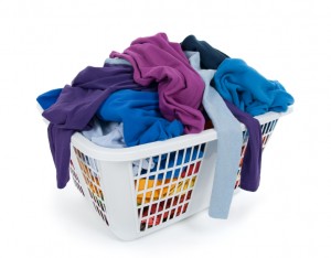 Bright clothes in laundry basket. Blue, indigo, purple.